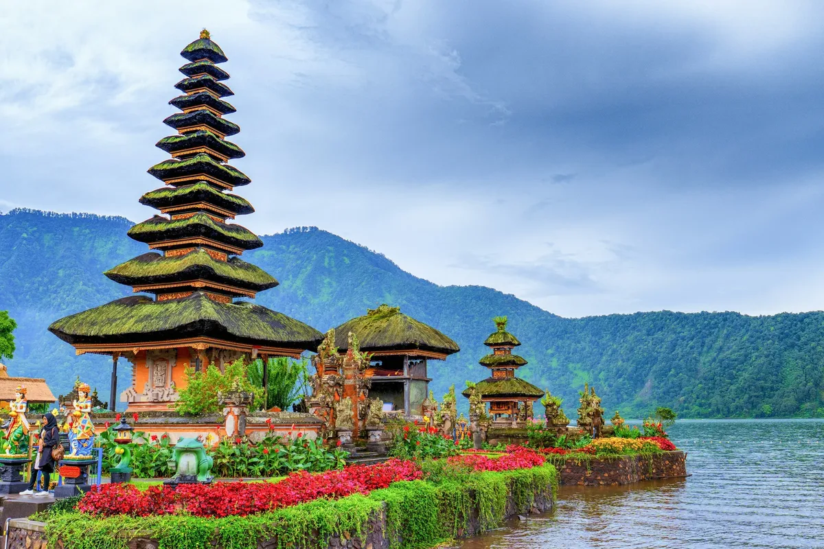 A beautiful temple with a pond in front of it.